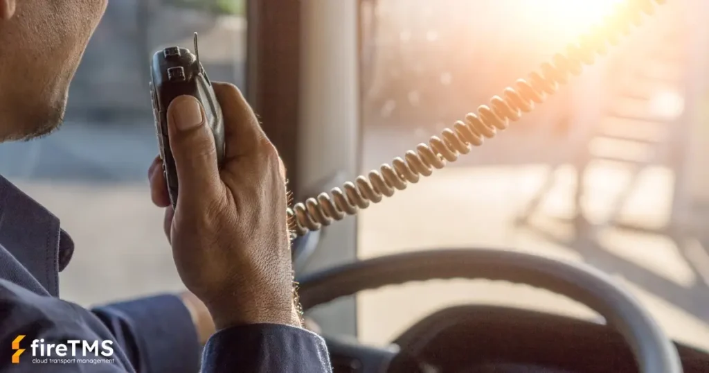 Kierowca samochodu ciężarowego rozmawia przez CB radio w trasie
