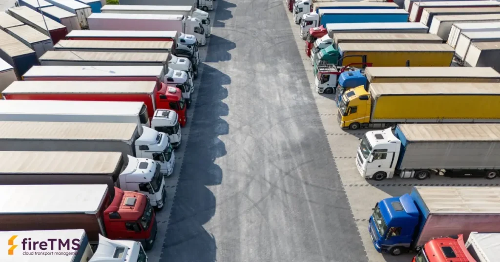 Samochody ciężarowe stojące na parkingu, za każdy z nich naliczany jest podatek drogowy